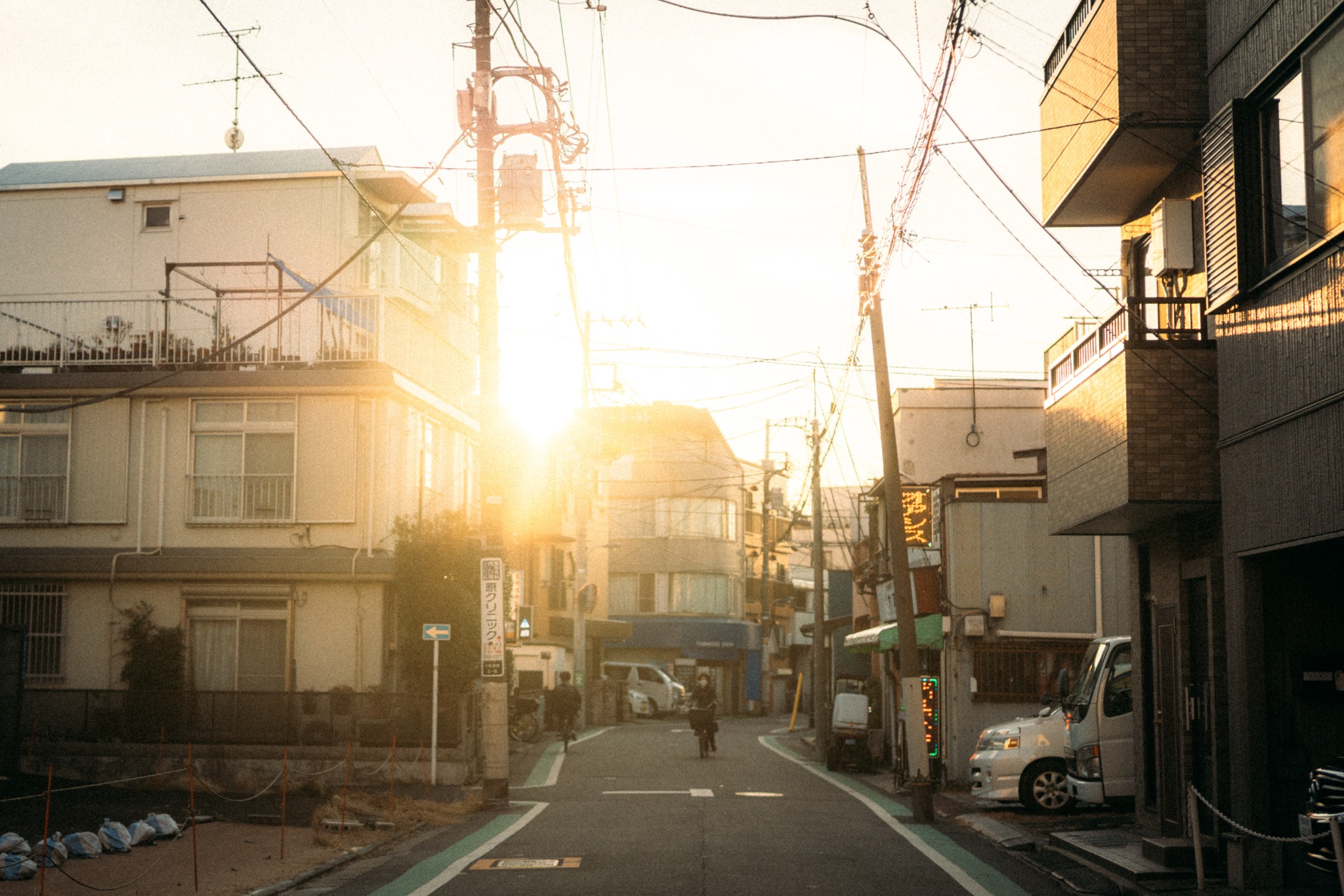 Low afternoon sunlight filling a narrow residential street
